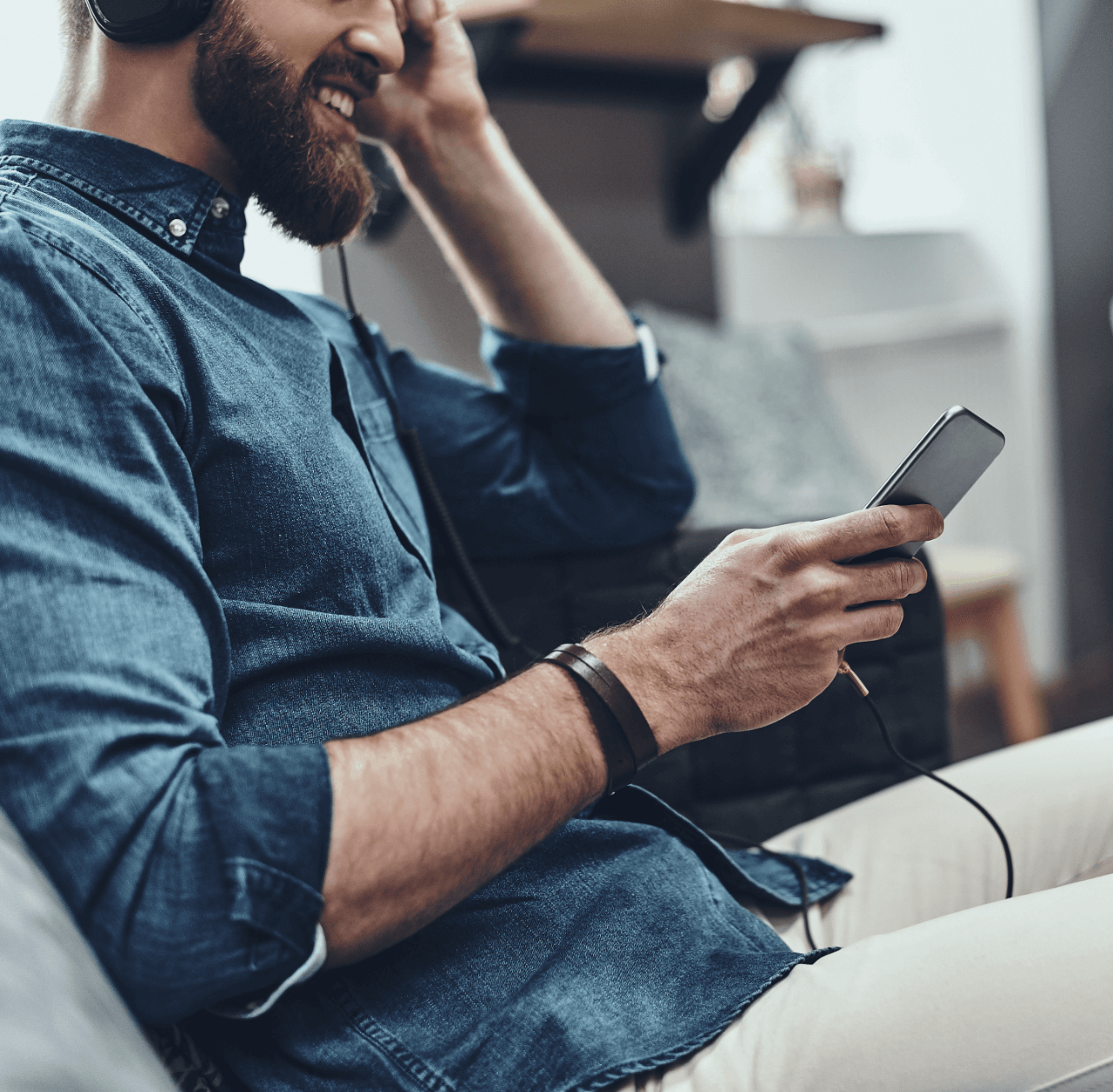 great-song-close-up-young-man-holding-mobile-phone-listening-music